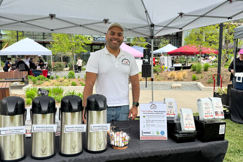 A photo of the founder, Andrew, at the MetPark farmers market in Arlington, VA at the SipSation booth.